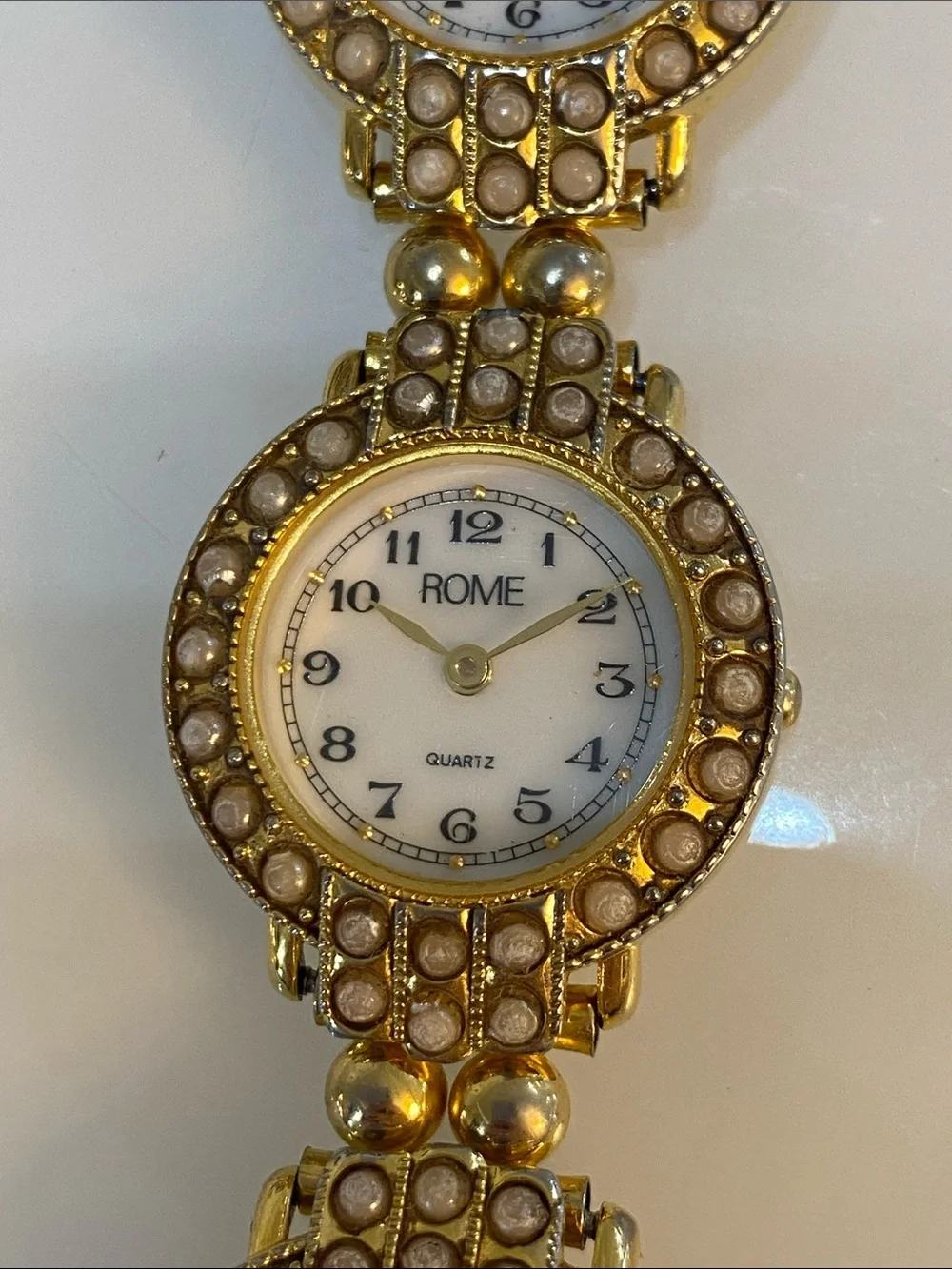 Faux pearl gold tone watch